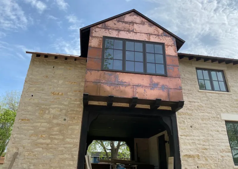 Copper metal panel facade on a stone building for Roof Repair in Hillsboro